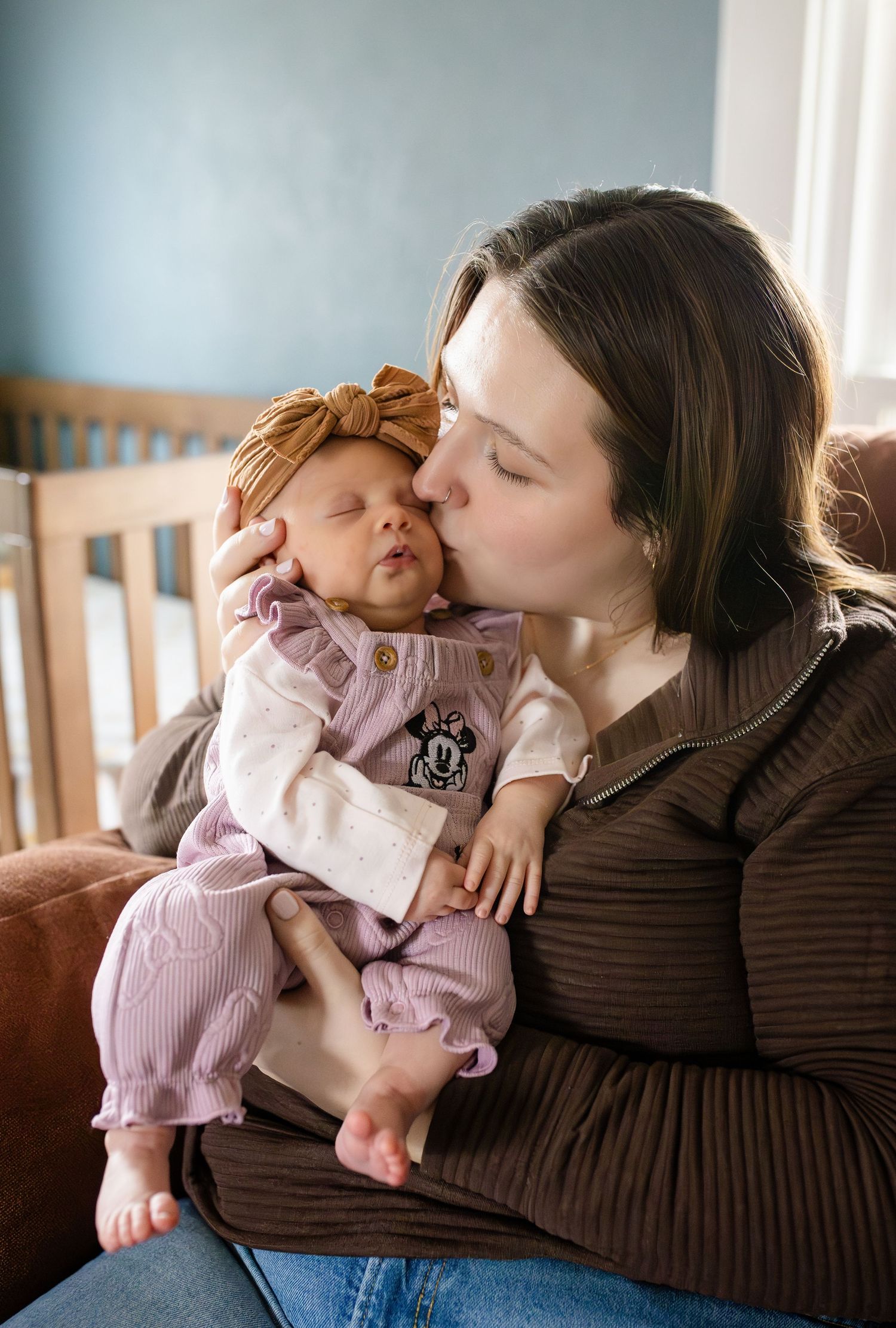 A tender moment of affection and bonding between parent and baby in a series of candid photos on a couch.