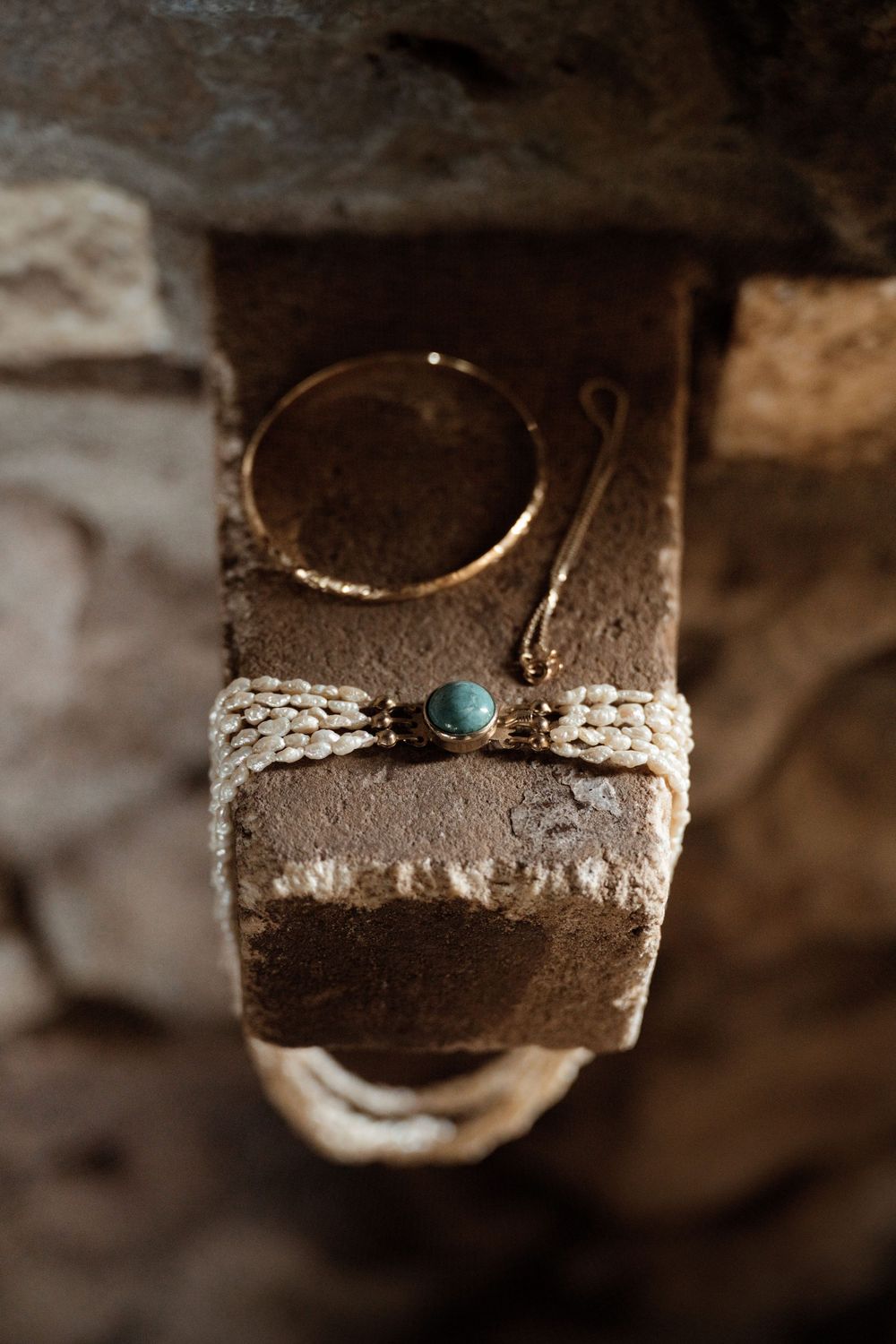 Close-up sequence showing stages of a handcrafted silver ring with turquoise stone being assembled in a jewelry workshop.