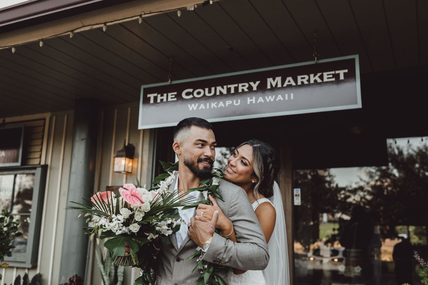 Wedding celebration at The Country Market venue with rustic exterior signage.