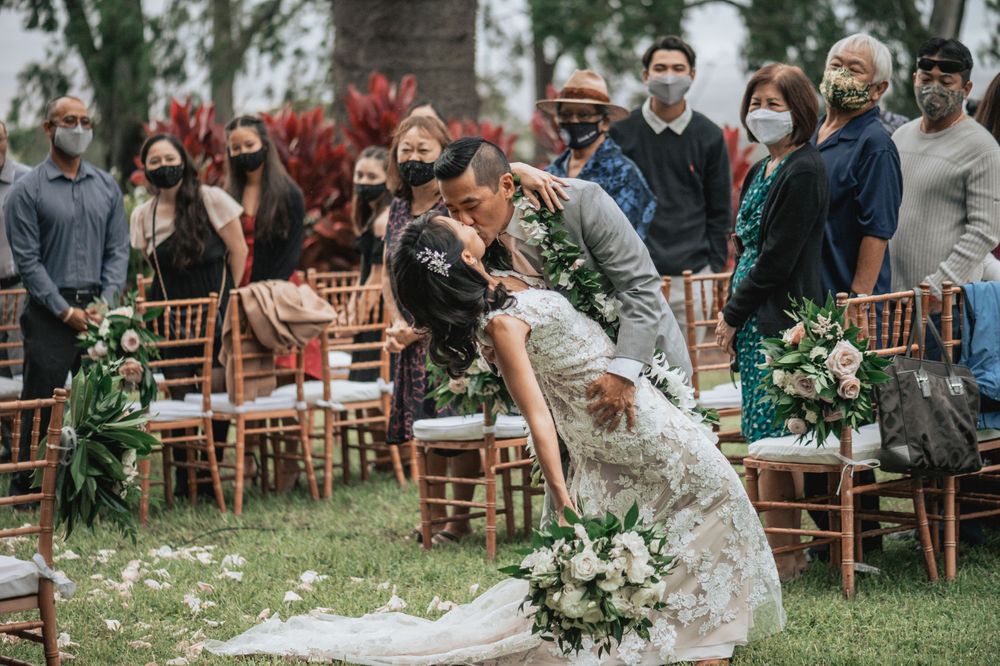 Wedding celebration in a garden setting with wooden chairs and natural decor.