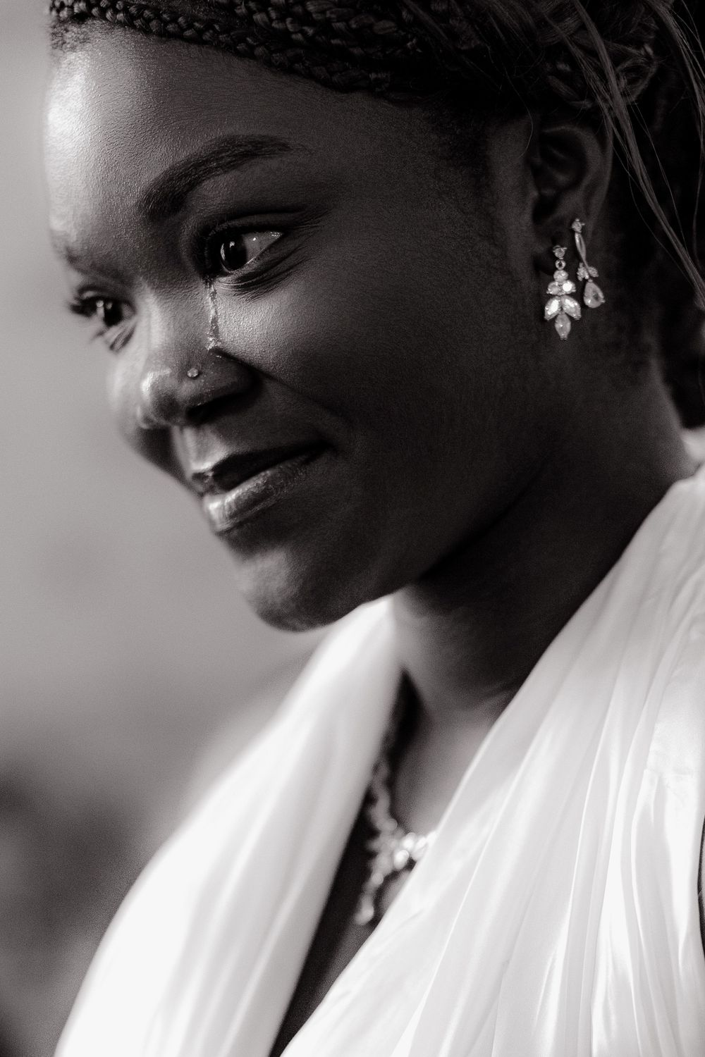 Black and white portrait series showing a person in a white garment with a soft, contemplative expression.