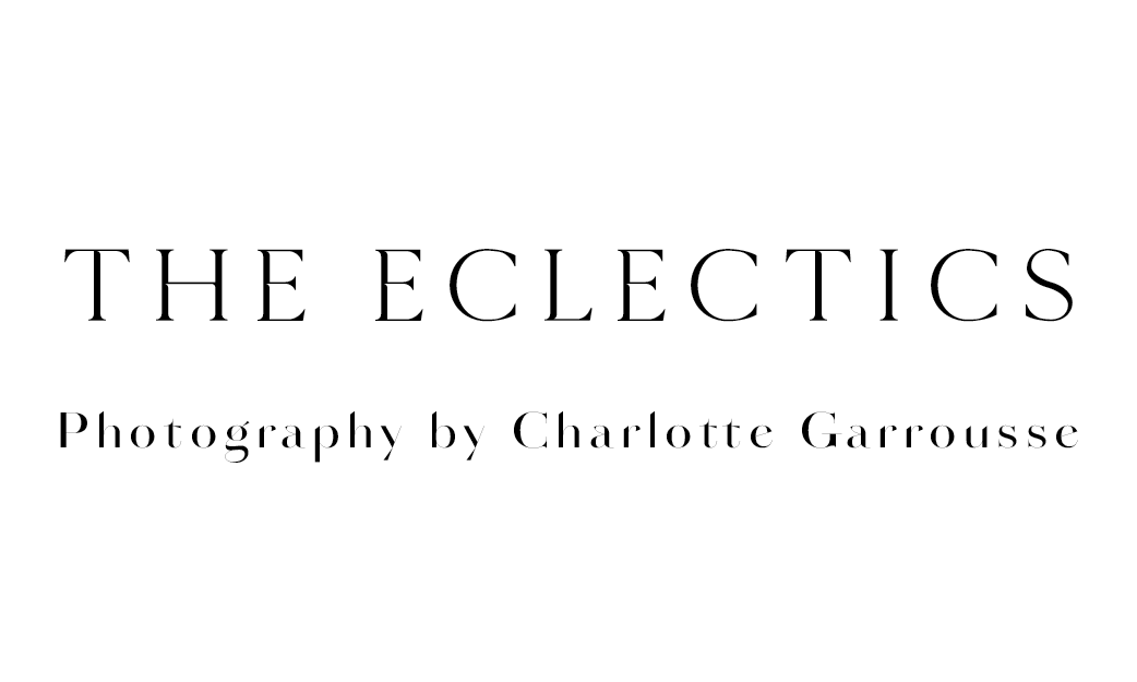 Stylish black text reading 'THE ECLECTICS' with 'Photography by Charlotte Garrousse' in smaller font against white.