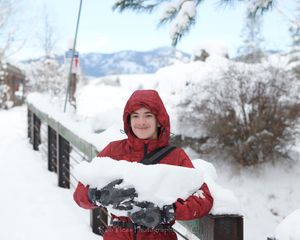 Marshall on the bridge in Twisp, WA holding a giant chunk of snow he found. 12/23/21.