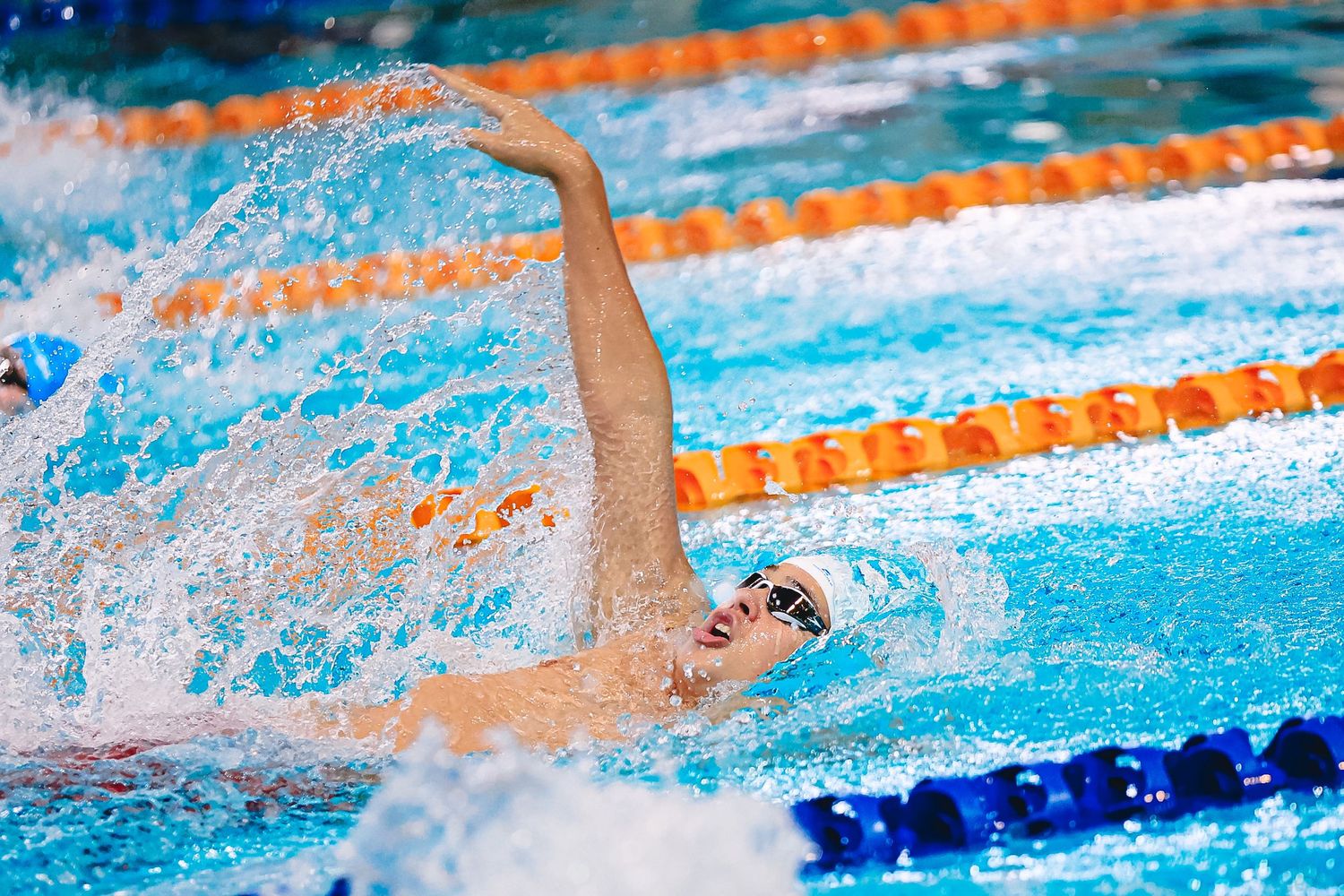 A close-up shot of hands placing white numbered blocks on a blue surface during a sports match or competition.