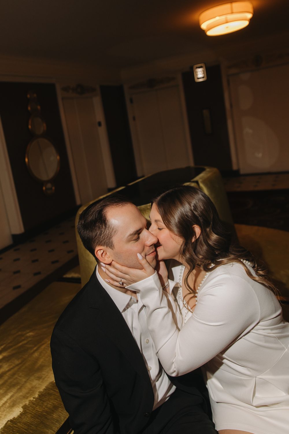 A romantic sequence of five photos showing a couple sharing intimate kisses in a dimly lit indoor setting.