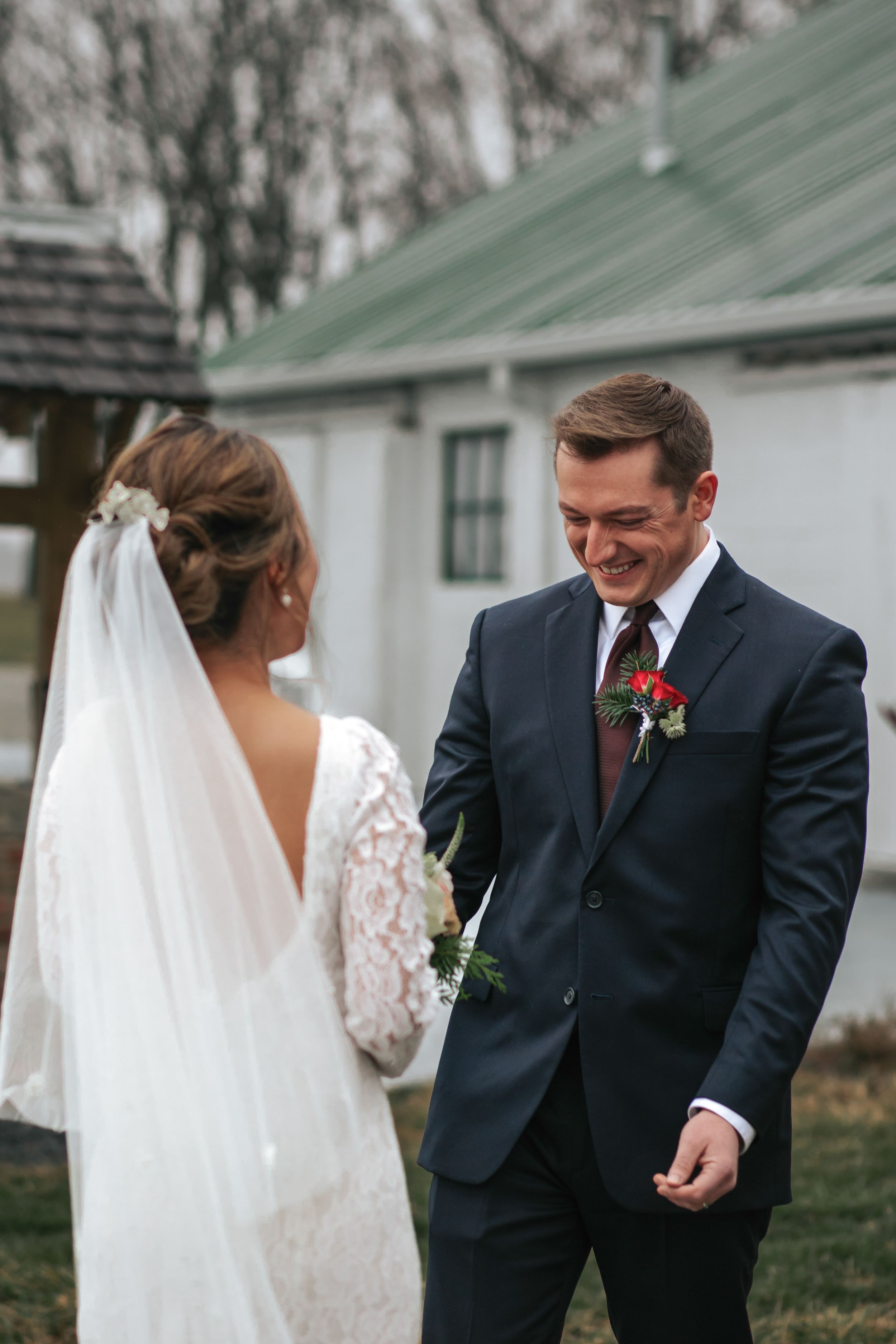 A series of emotional first look moments between a bride in a lace gown and her father at an outdoor wedding venue.