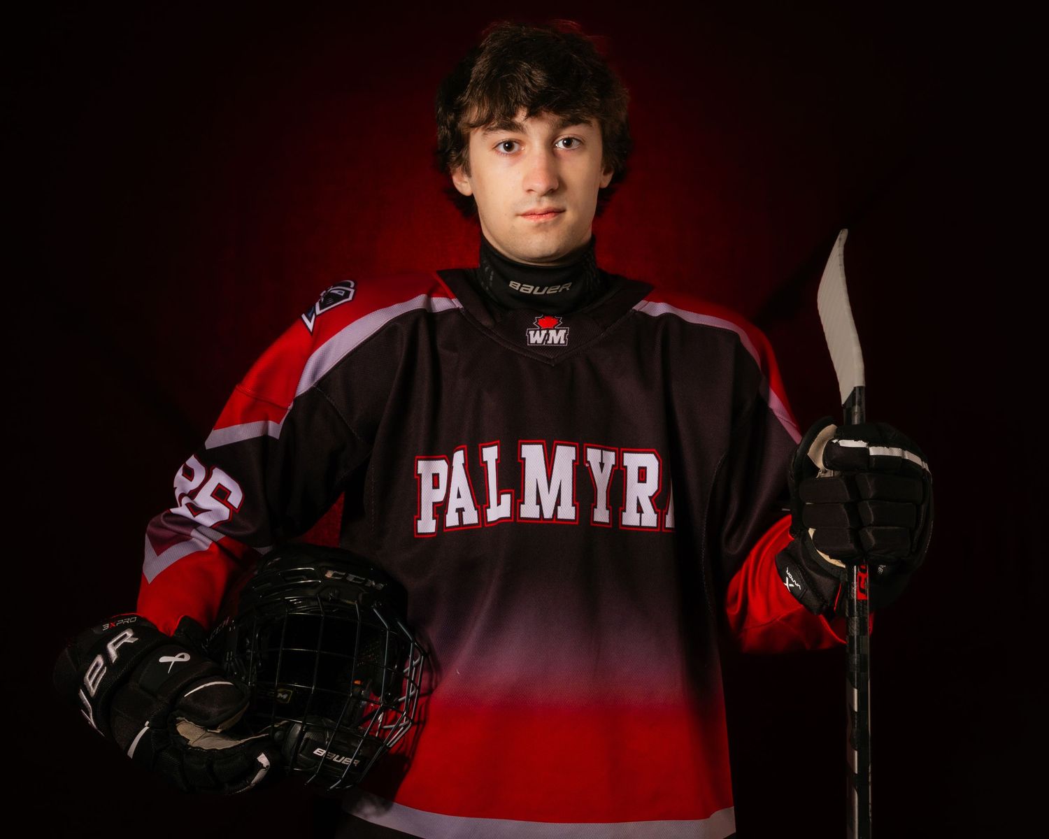 Palmyra Black Knights high school hockey player portrait in red jersey, dramatic lighting, Central Pennsylvania, by SportsFox Photography