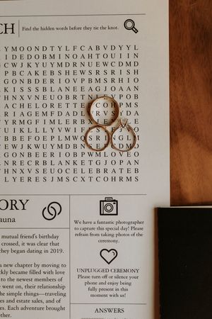 A wedding-themed word search puzzle page with rings and ceremony symbols in sepia tones.