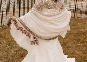 Flowing white wedding dress details shown in a series of sepia-tinted photographs capturing movement and elegance.