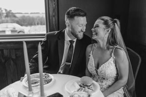 Black and white photos show a couple sharing intimate moments while drinking from bottles at their wedding reception.