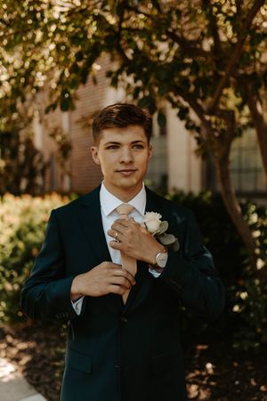 A series of artistic wedding photos showing emotional moments with a groom in a dark suit against a natural backdrop.