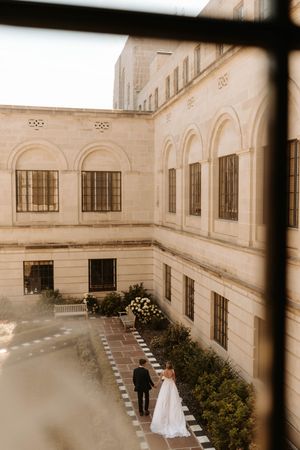 Architectural wedding venue photos showing elegant arched windows and courtyard in sepia tones.