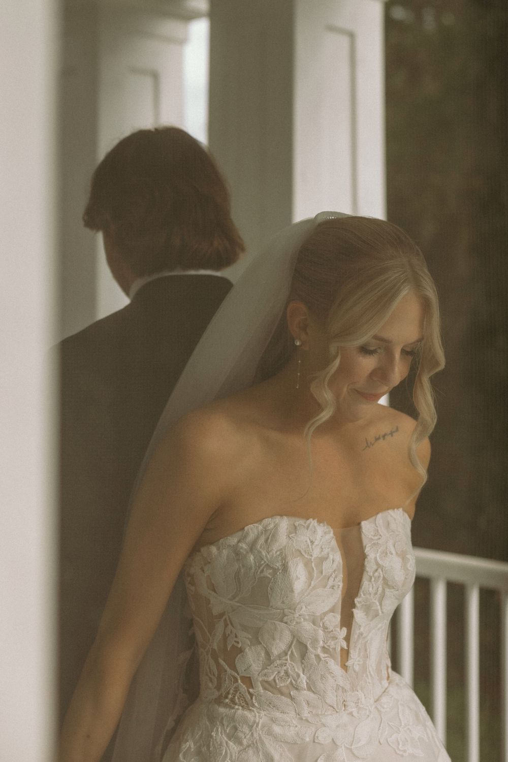 Bride and groom first touch on the balcony at The Elms of Coosada in Coosada, Alabama