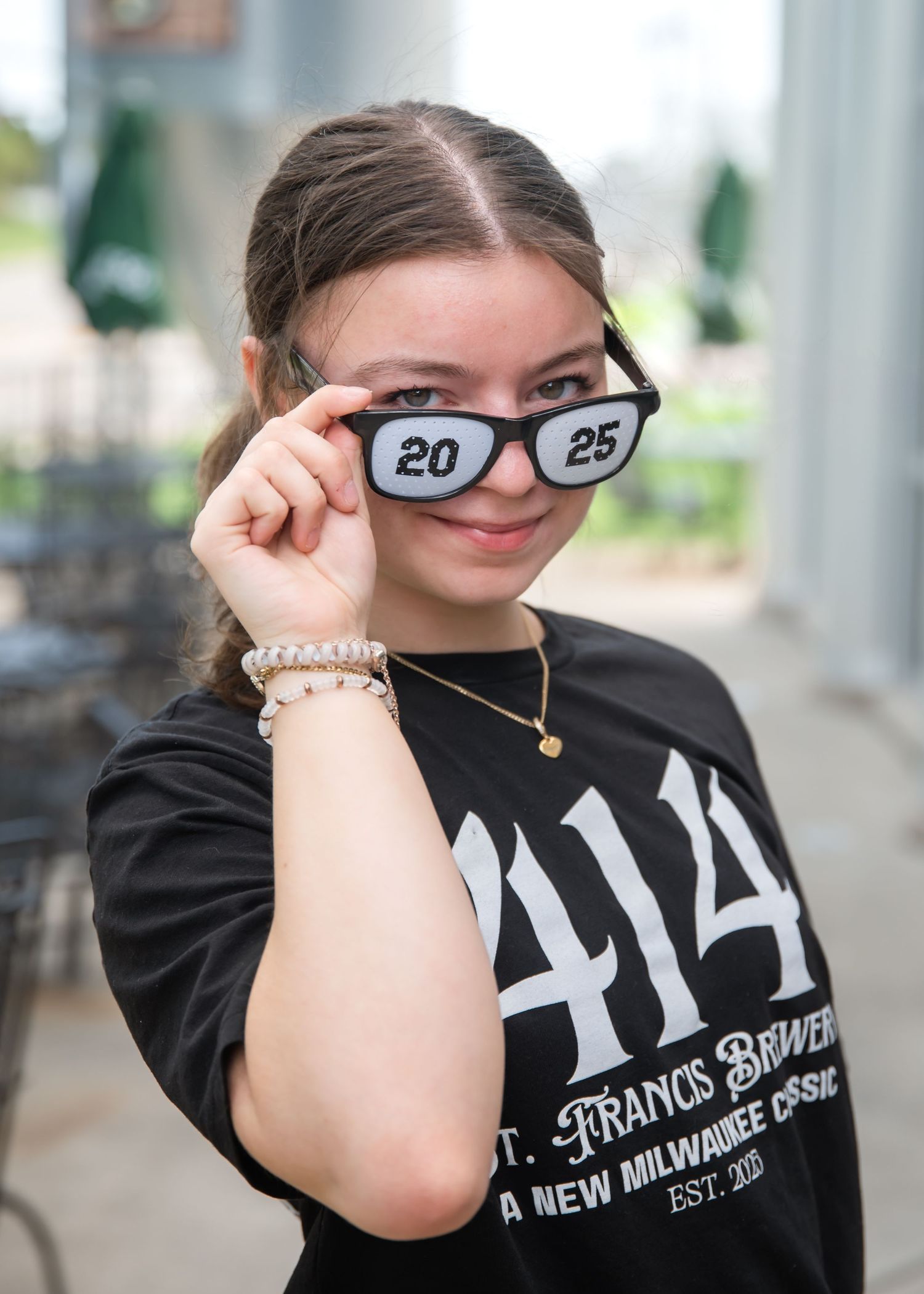Person wearing black Pink Floyd t-shirt and glasses poses playfully in a sequence of photos.