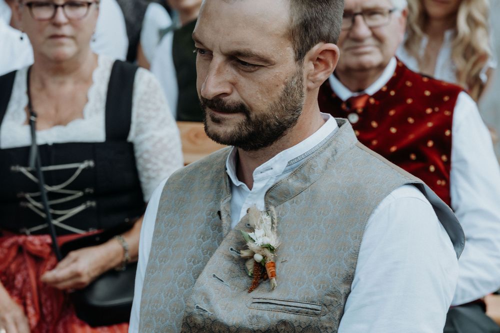 Wedding party members giving emotional speeches during an outdoor reception.