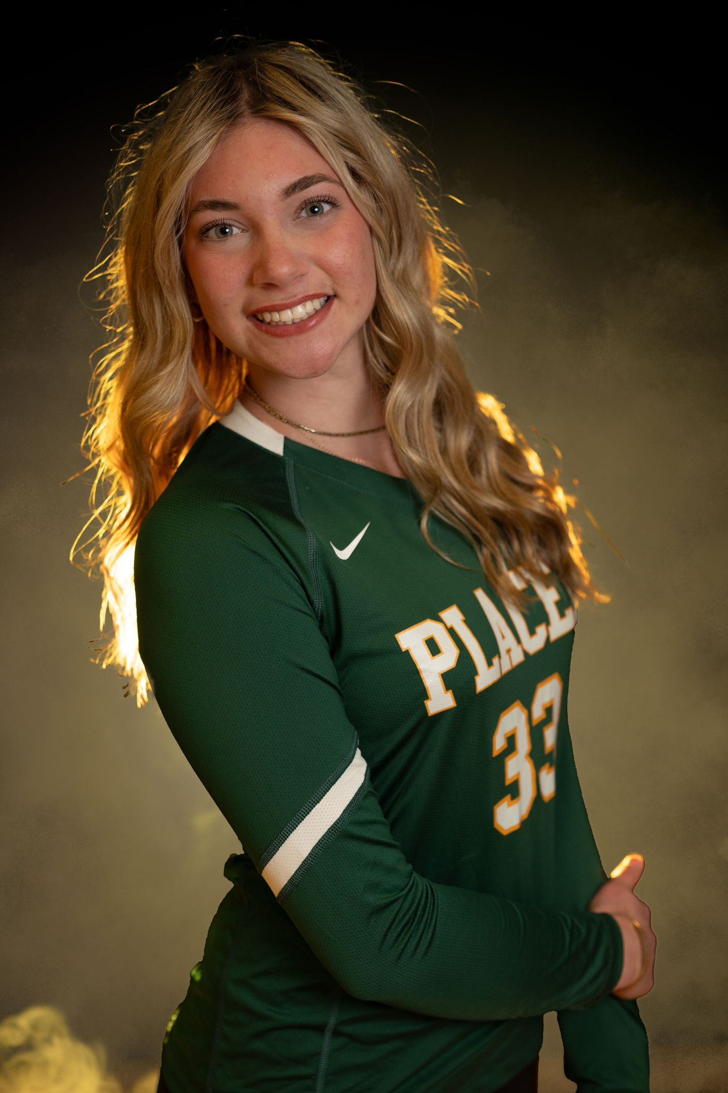 Athletic portrait series showing person in green and white sports uniform with dramatic rim lighting effect.