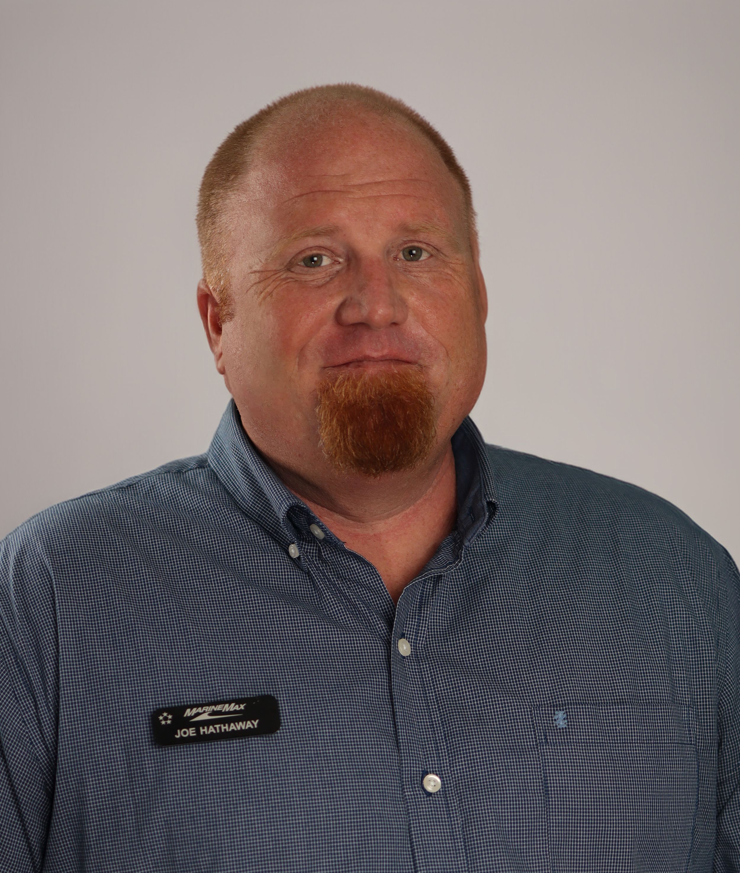 A series of professional headshots showing someone in a blue button-down shirt against a light gray background.