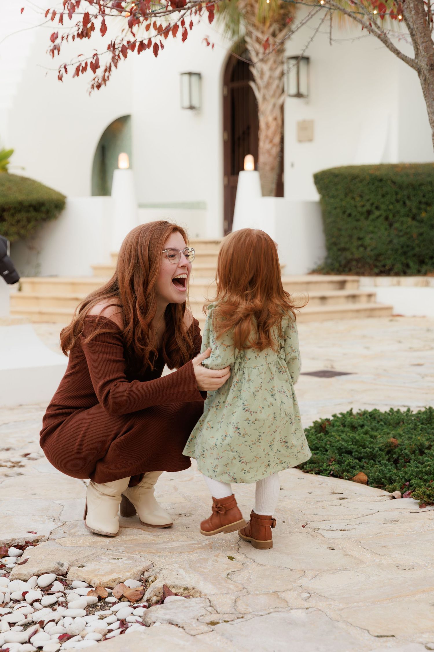 A series of candid moments showing playful interaction on a stone patio with white walls and autumn foliage.