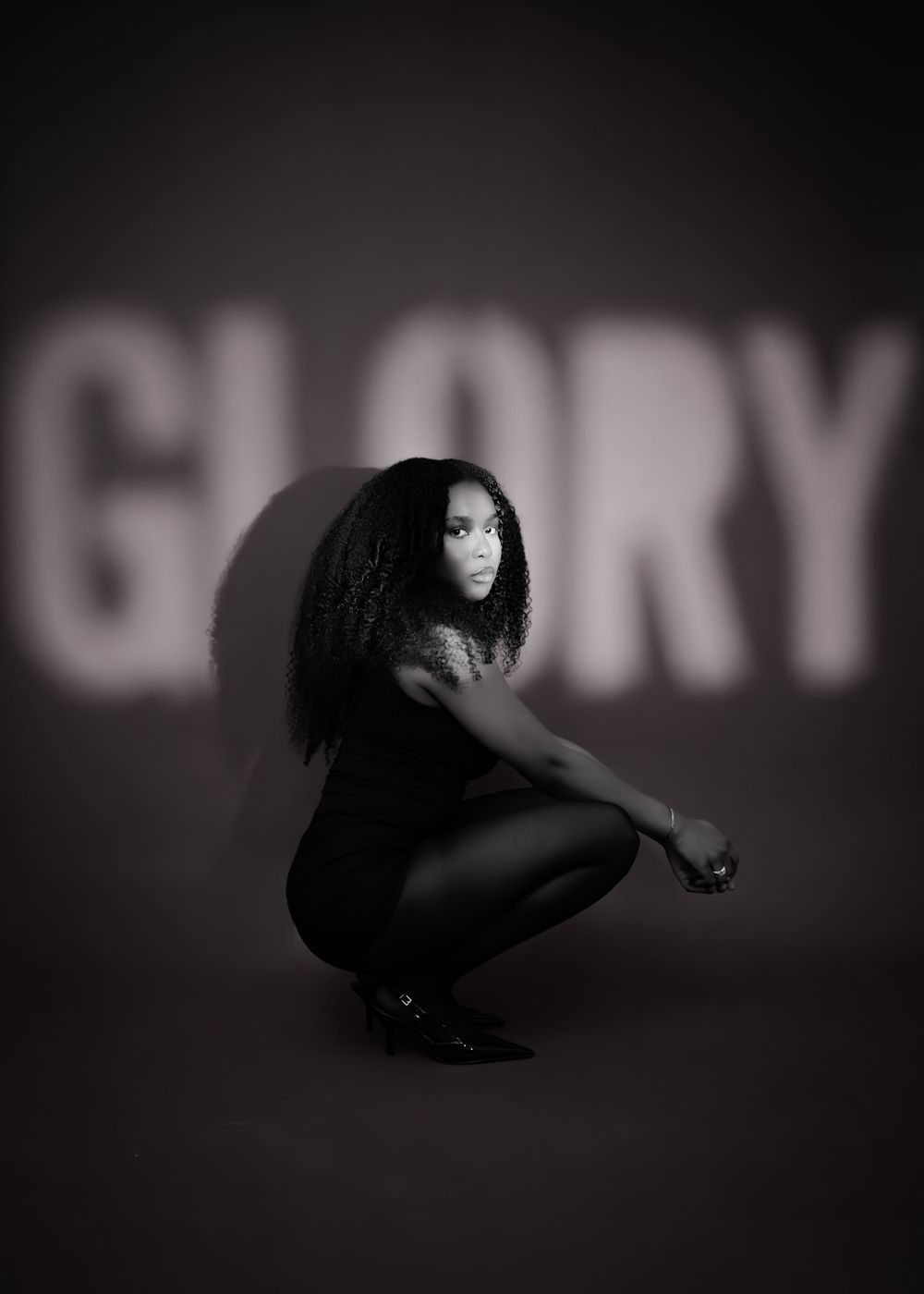 A dramatic black and white sequence shows a figure in dark clothing moving through crouched positions against a shadowy wall.