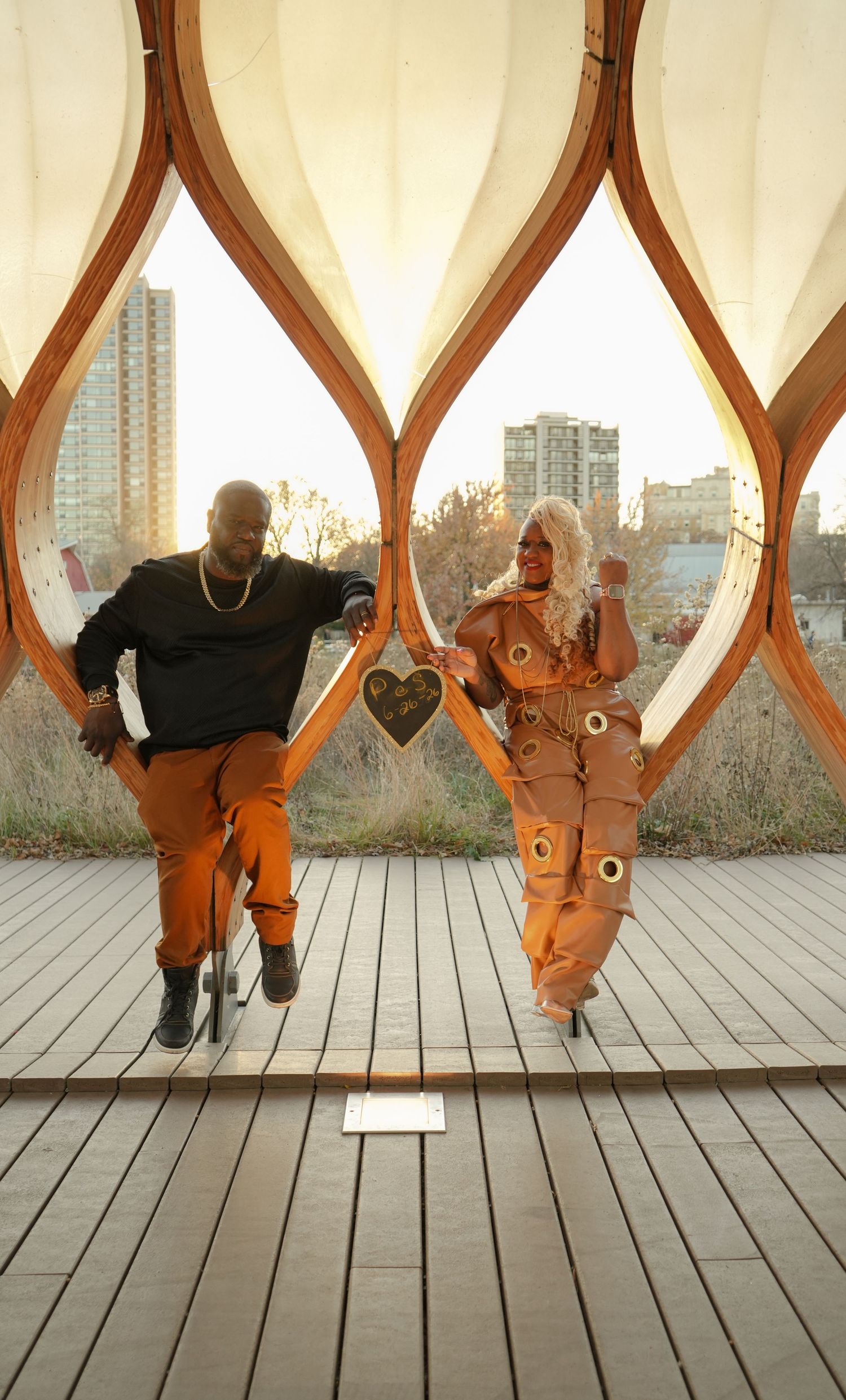 A sequence of dance moves shown in five connected frames on a wooden deck with geometric railings in the background.