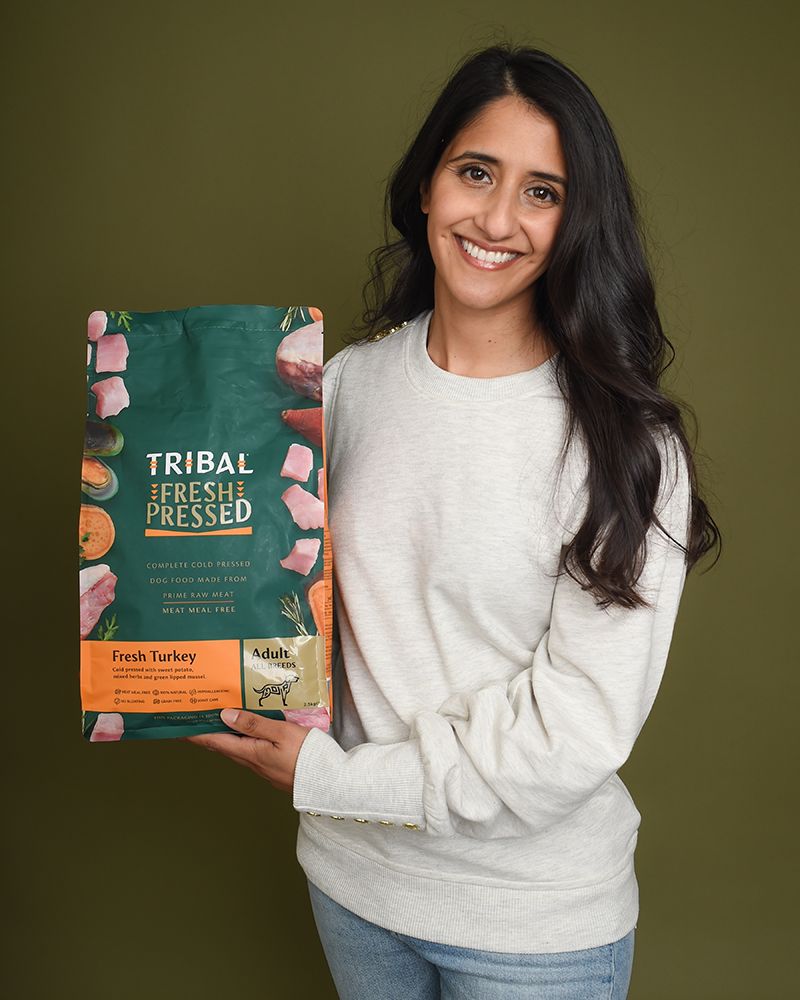 Fatima Maktari holding a bag of Tribal Fresh Pressed dog food during a branding photoshoot.