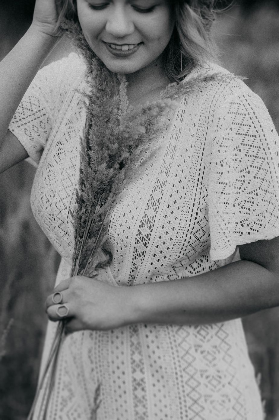 A black and white photo series showing a person in a delicate white lace dress smiling in an outdoor setting.