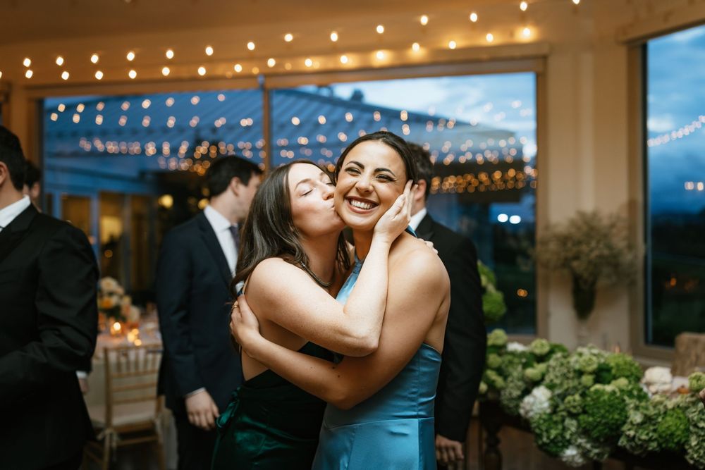Wedding celebration sequence showing dancing and romantic moments under warm string lights at an evening reception.