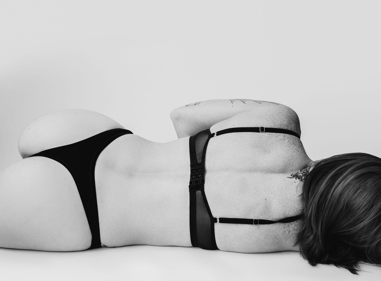 A series of minimalist black and white photographs showing silhouettes of pillows arranged in a horizontal row.