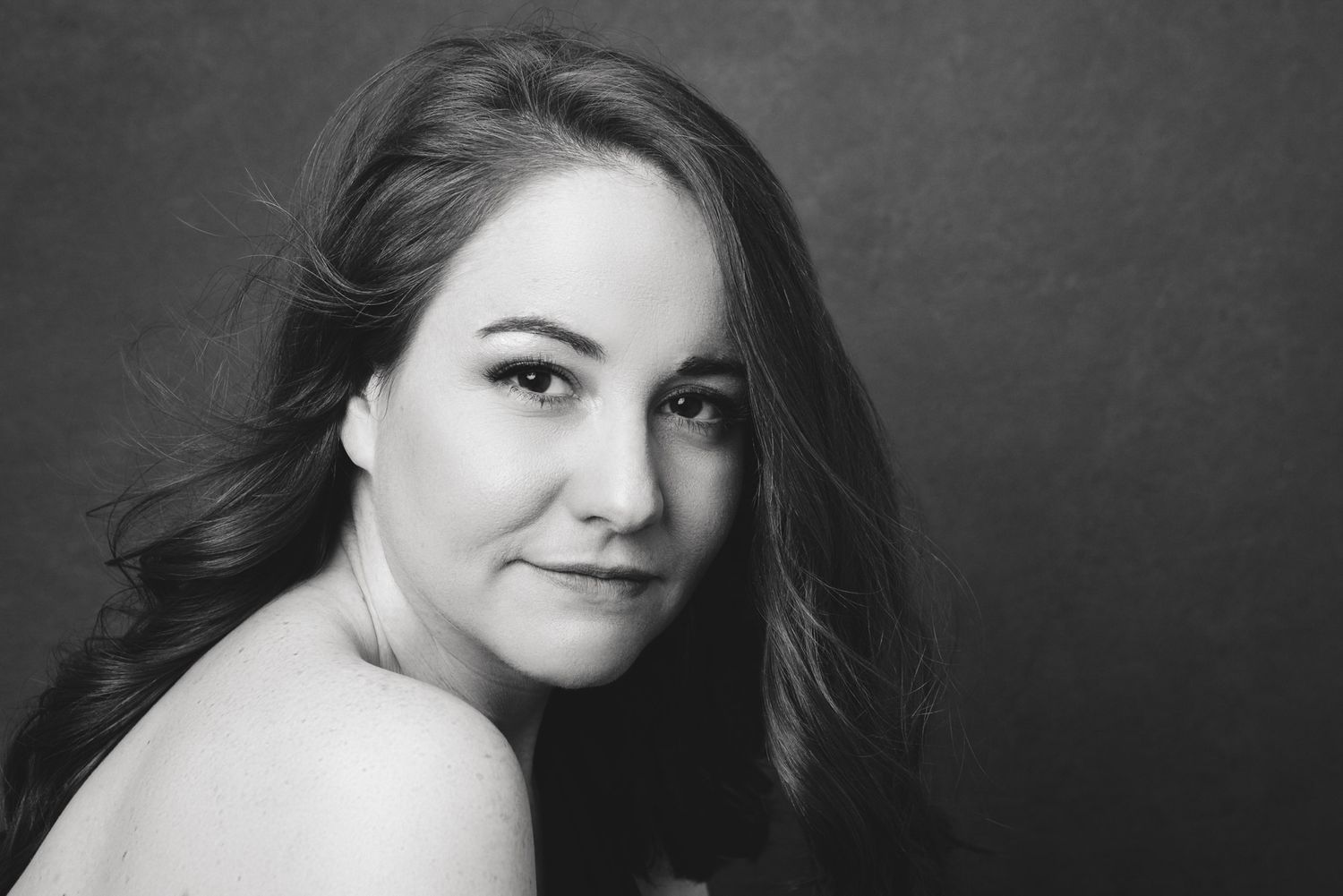 A series of black and white portraits showing the same person in different poses and expressions.