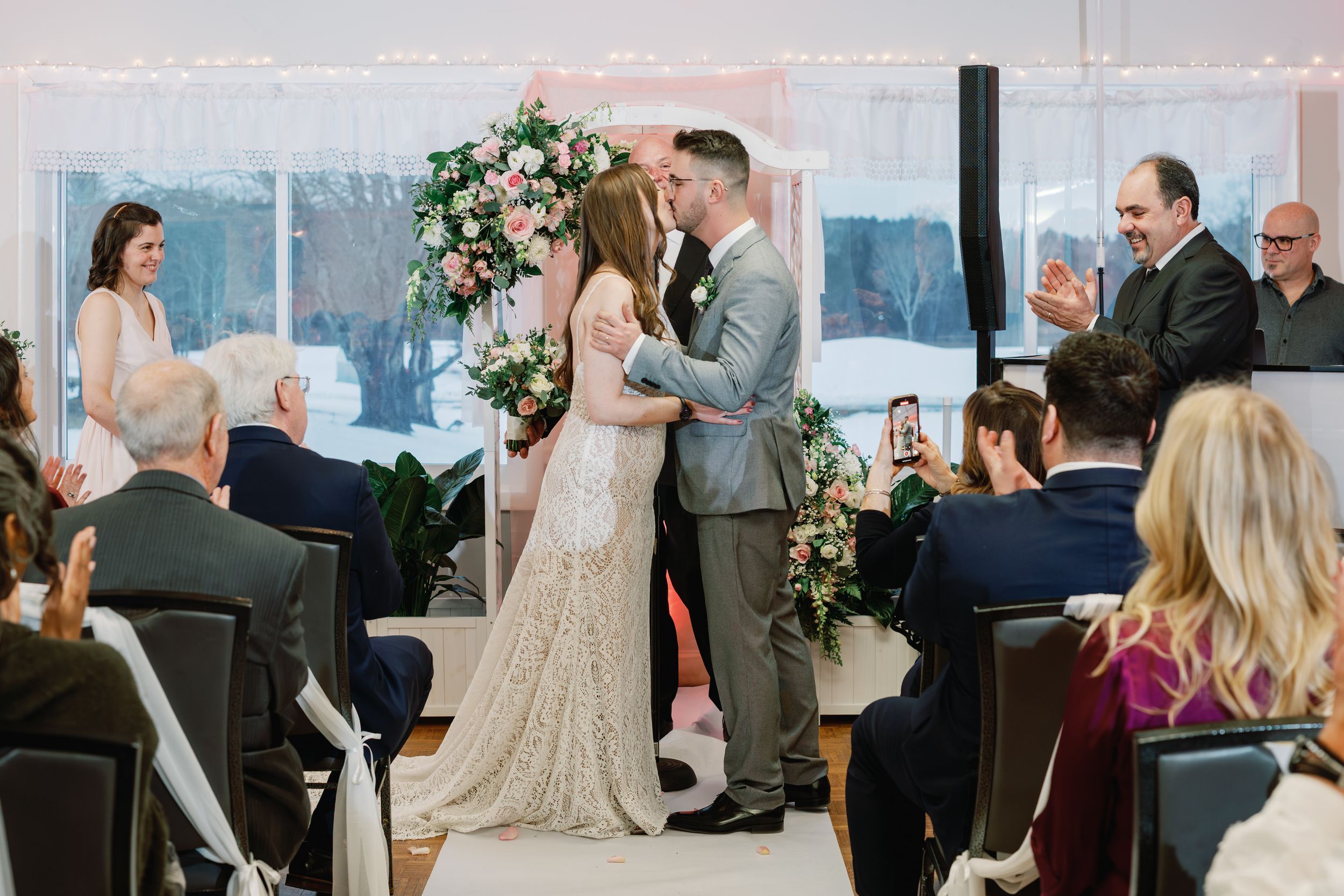 A wedding ceremony collage showing romantic moments and celebrations in an elegant venue with floral decorations.