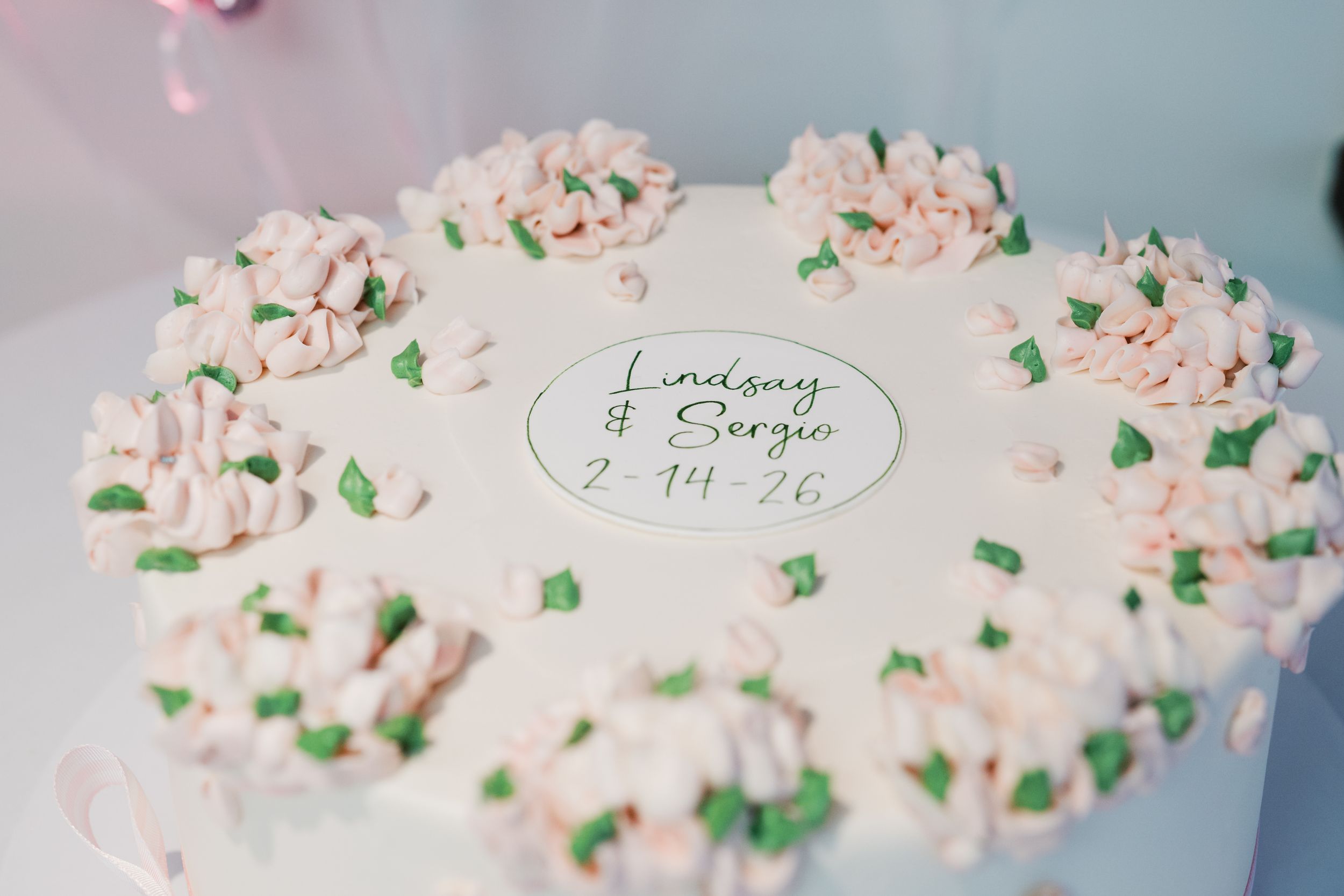 A white frosted birthday cake decorated with pink and green sprinkles shown from multiple angles on a light background.