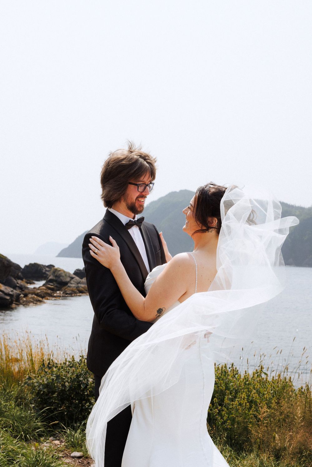 Bride and groom share first look in Dunfield on Bonavista Peninsula by Newfoundland documentary wedding photographer Kaitlyn Yvette