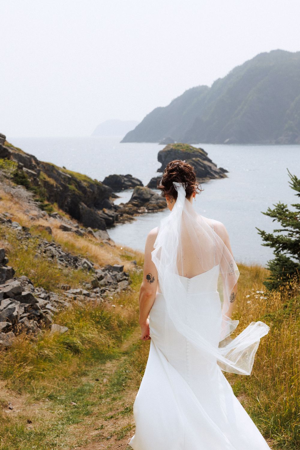 Bride and groom share first look in Dunfield on Bonavista Peninsula by Newfoundland documentary wedding photographer Kaitlyn Yvette