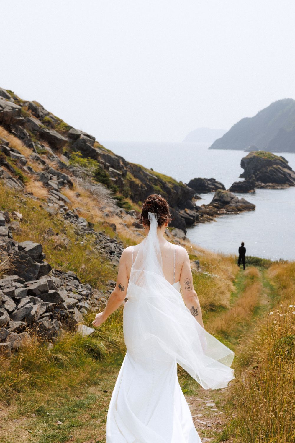 Bride and groom share first look in Dunfield on Bonavista Peninsula by Newfoundland documentary wedding photographer Kaitlyn Yvette