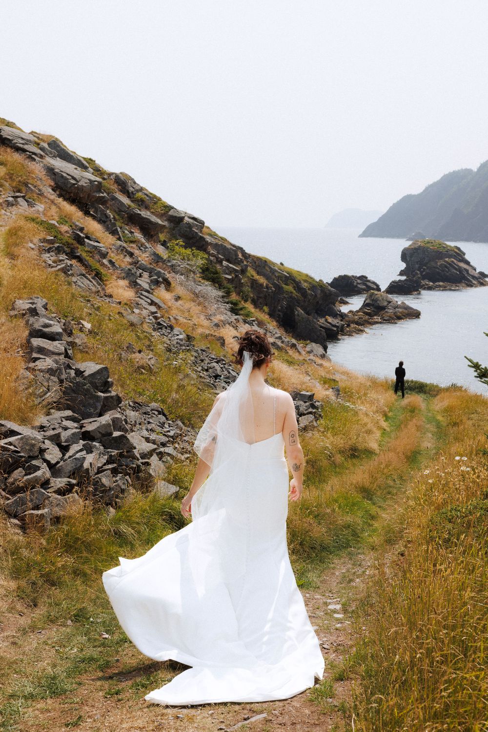 Bride and groom share first look in Dunfield on Bonavista Peninsula by Newfoundland documentary wedding photographer Kaitlyn Yvette