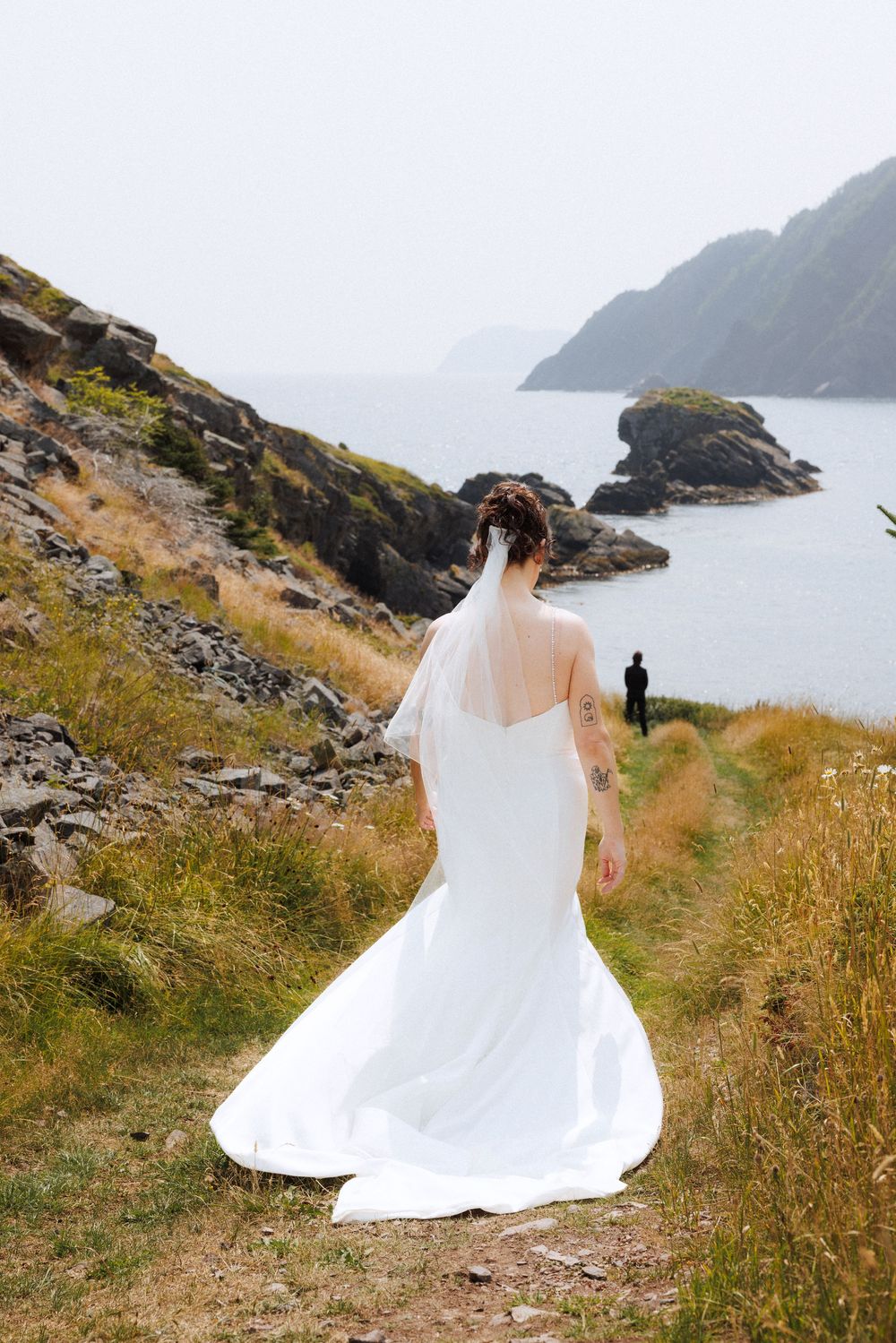 Bride and groom share first look in Dunfield on Bonavista Peninsula by Newfoundland documentary wedding photographer Kaitlyn Yvette