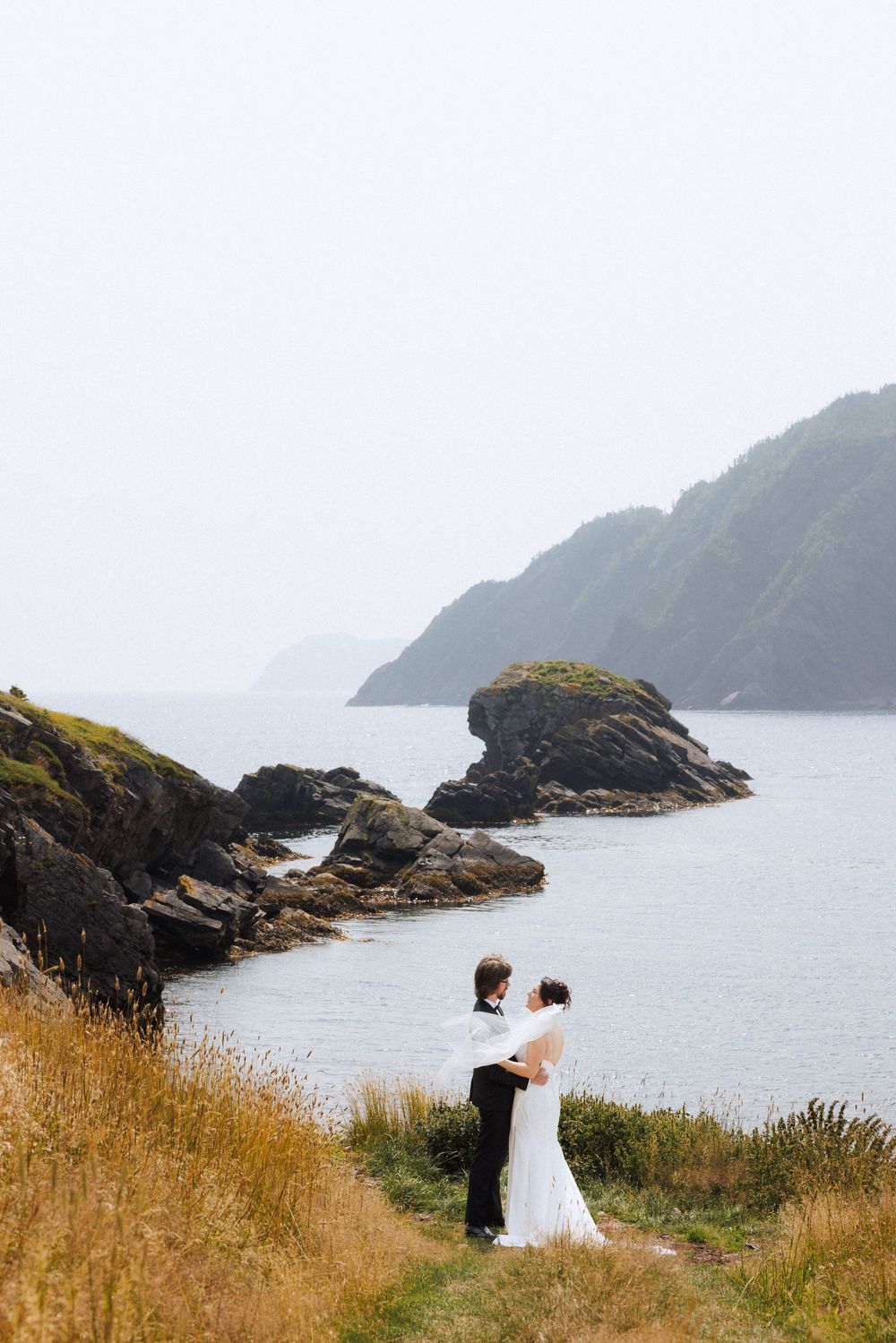 Bride and groom share first look in Dunfield on Bonavista Peninsula by Newfoundland documentary wedding photographer Kaitlyn Yvette