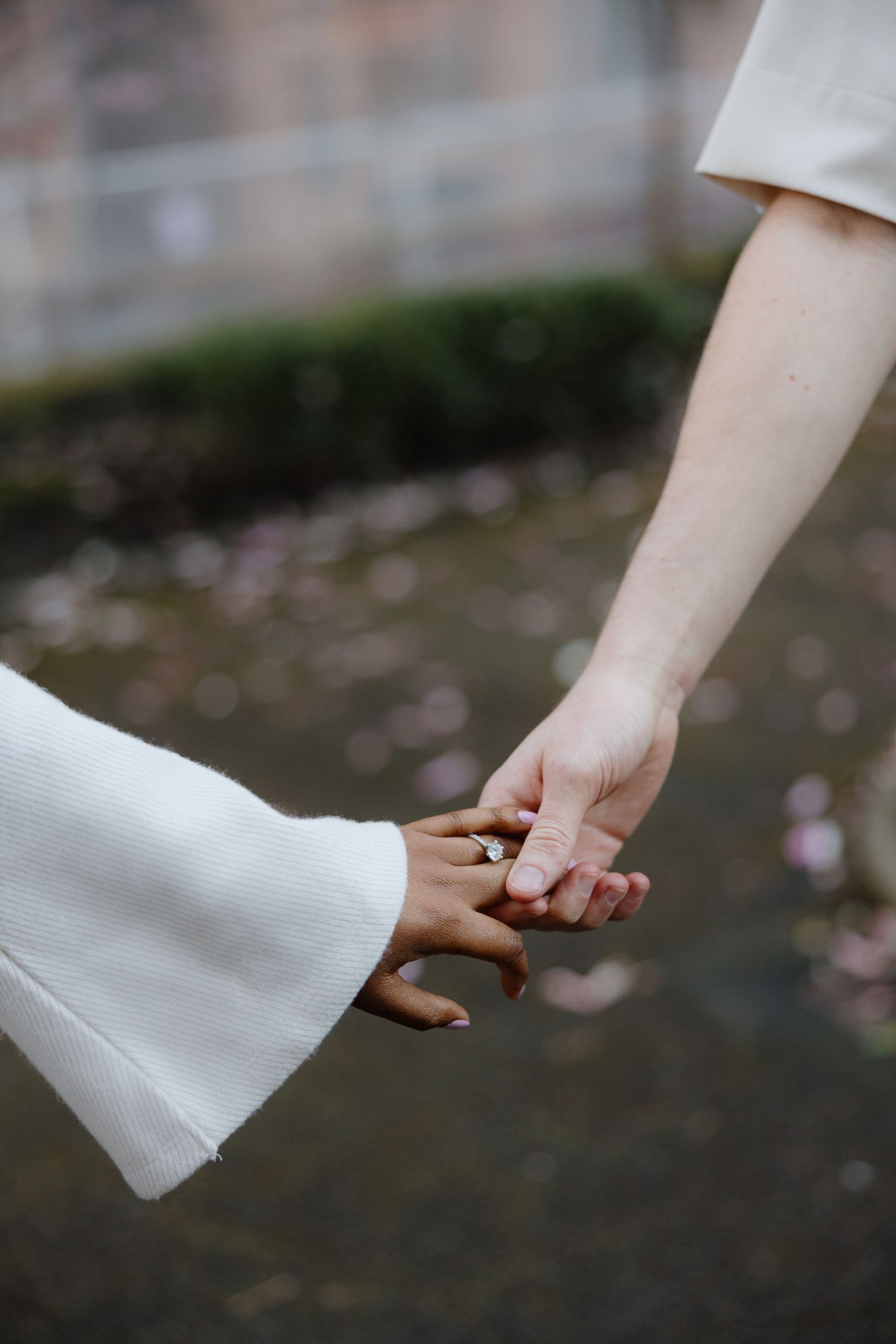 A series of romantic wedding photos showing a couple holding hands on a sandy beach in formal attire.