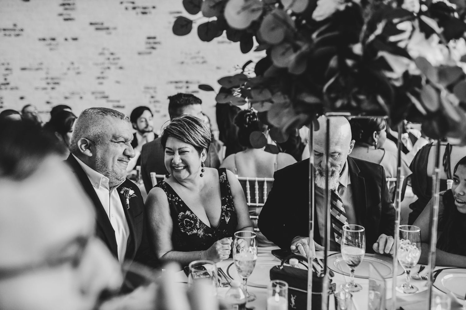 candid moment of father and mother of the bride candidly laughing at the reception