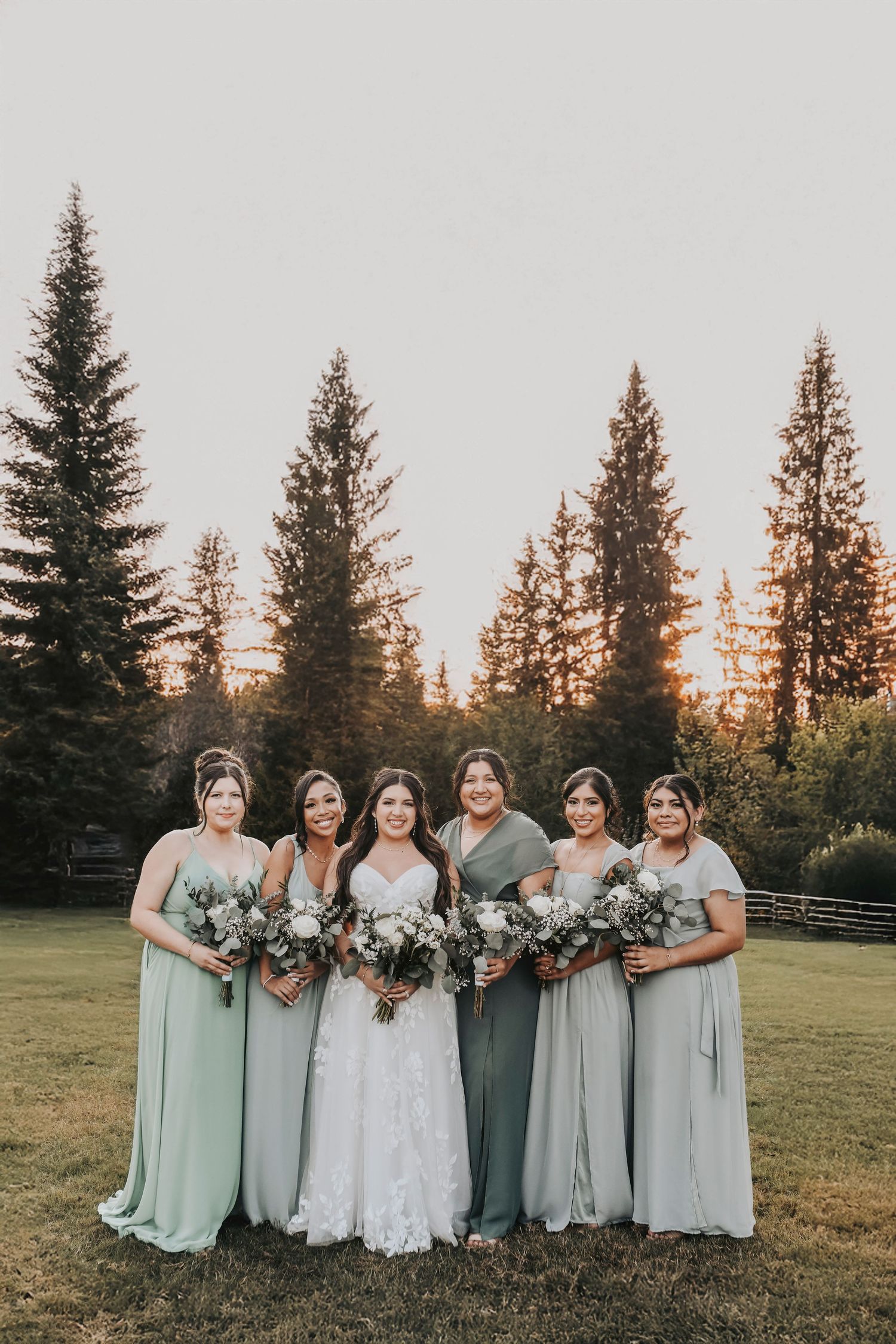 Sage green bridesmaids holding bouquets at Firefly Gardens wedding venue