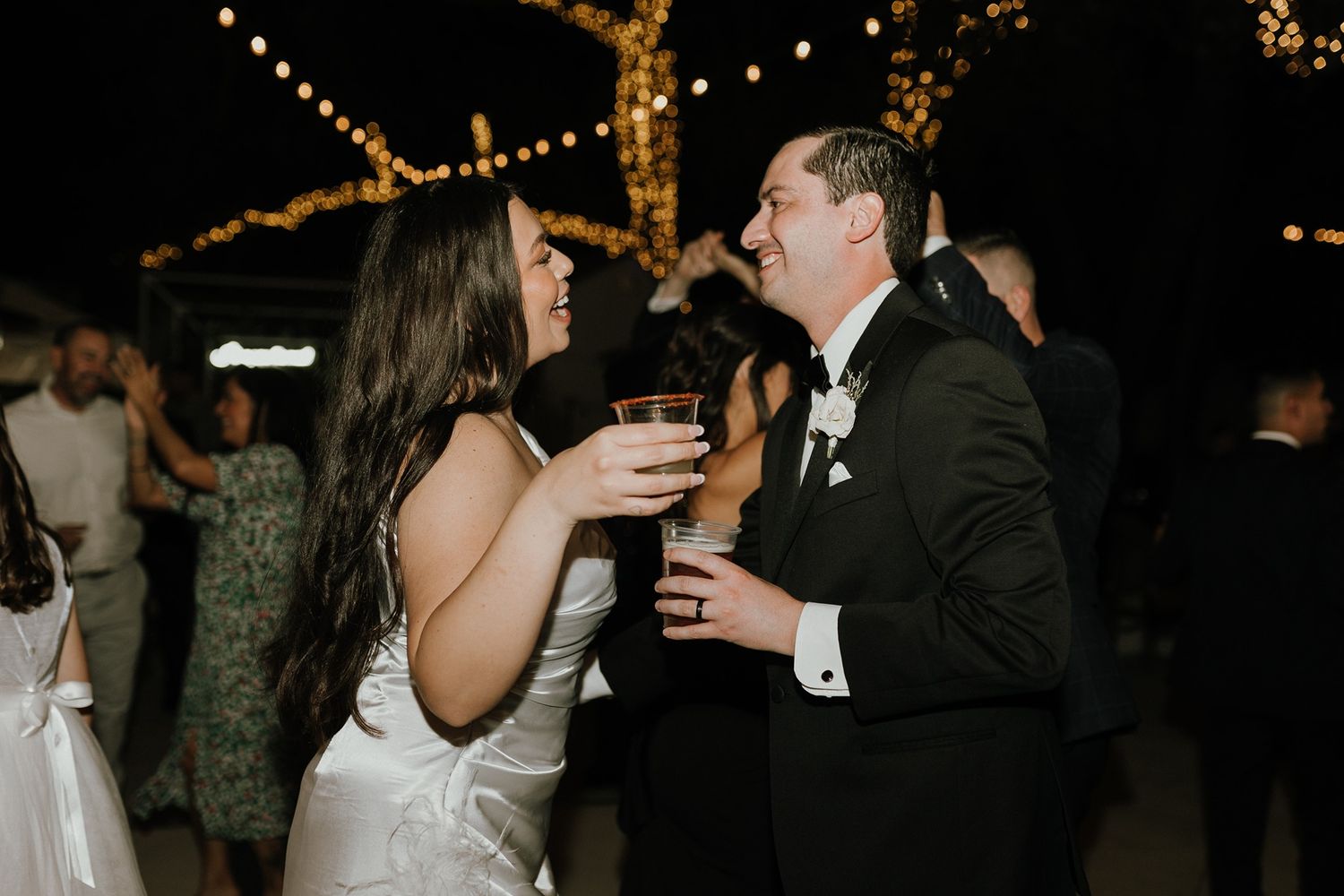 A couple shares a romantic dance moment at an evening wedding reception at The Oaks at Duncan Lane.
