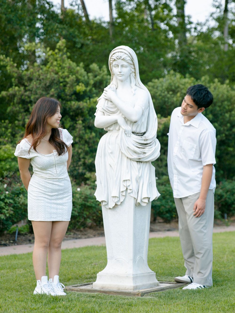 A sequence of photos showing people interacting with a white garden statue in an outdoor setting.