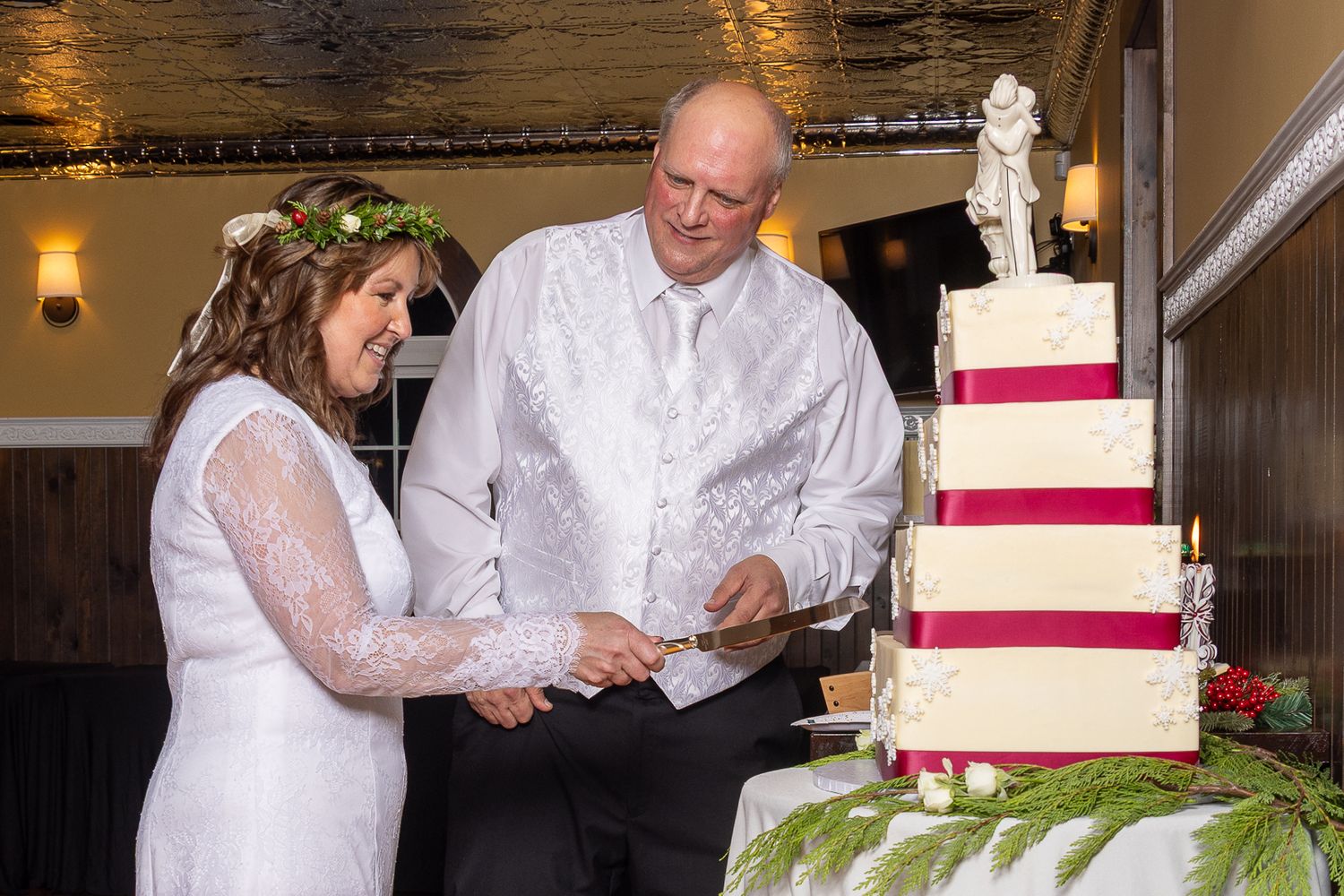 Frederick Maryland Wedding Photographer  Wedding couple cuts their elegant red and white tiered cake together at their reception.