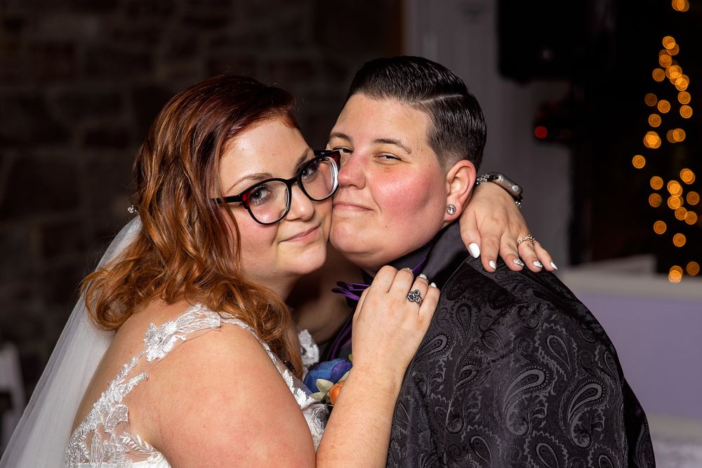 A bride and groom share intimate kisses in a series of five connected wedding photos with bokeh lights in background.