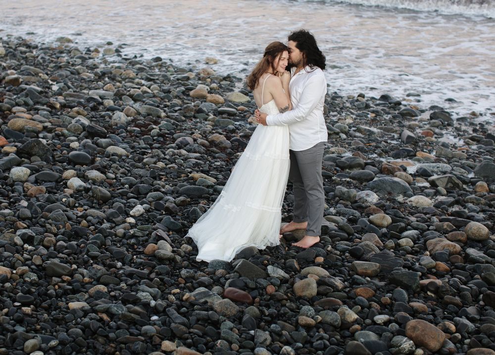 Husband and wife in wedding attire stand on a rocky beach in North Hampton for a styled shoot. Seacoast NH, North Shore wedding photographer
