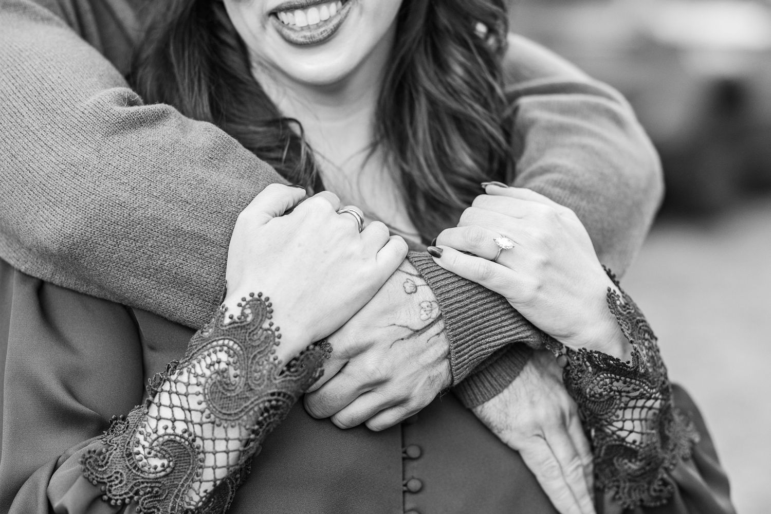A black and white photo montage shows close-up shots of hands wearing engagement rings.