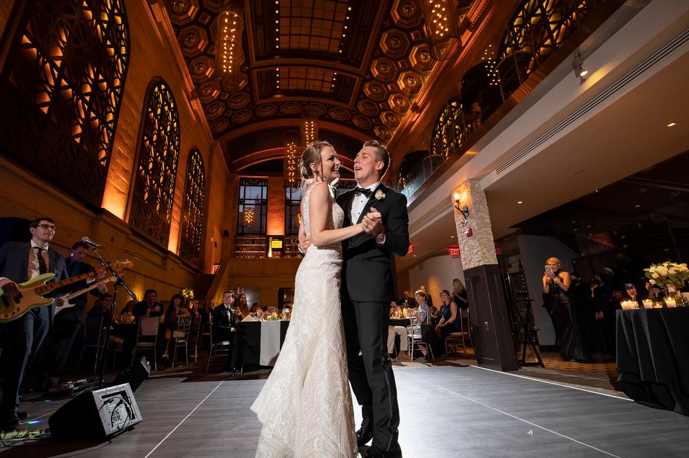 Elegant ballroom decorated with warm lighting and string lights for an evening wedding celebration at a Union Trust wedding