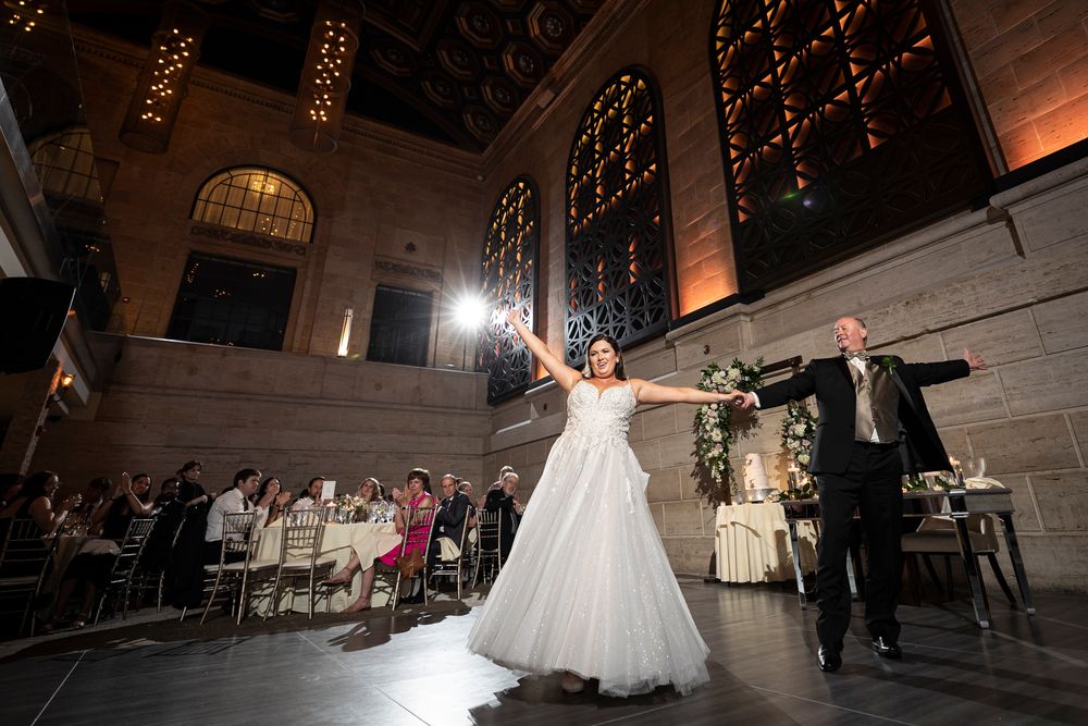 Wedding reception venue with dramatic lighting and architectural details creating a romantic atmosphere.