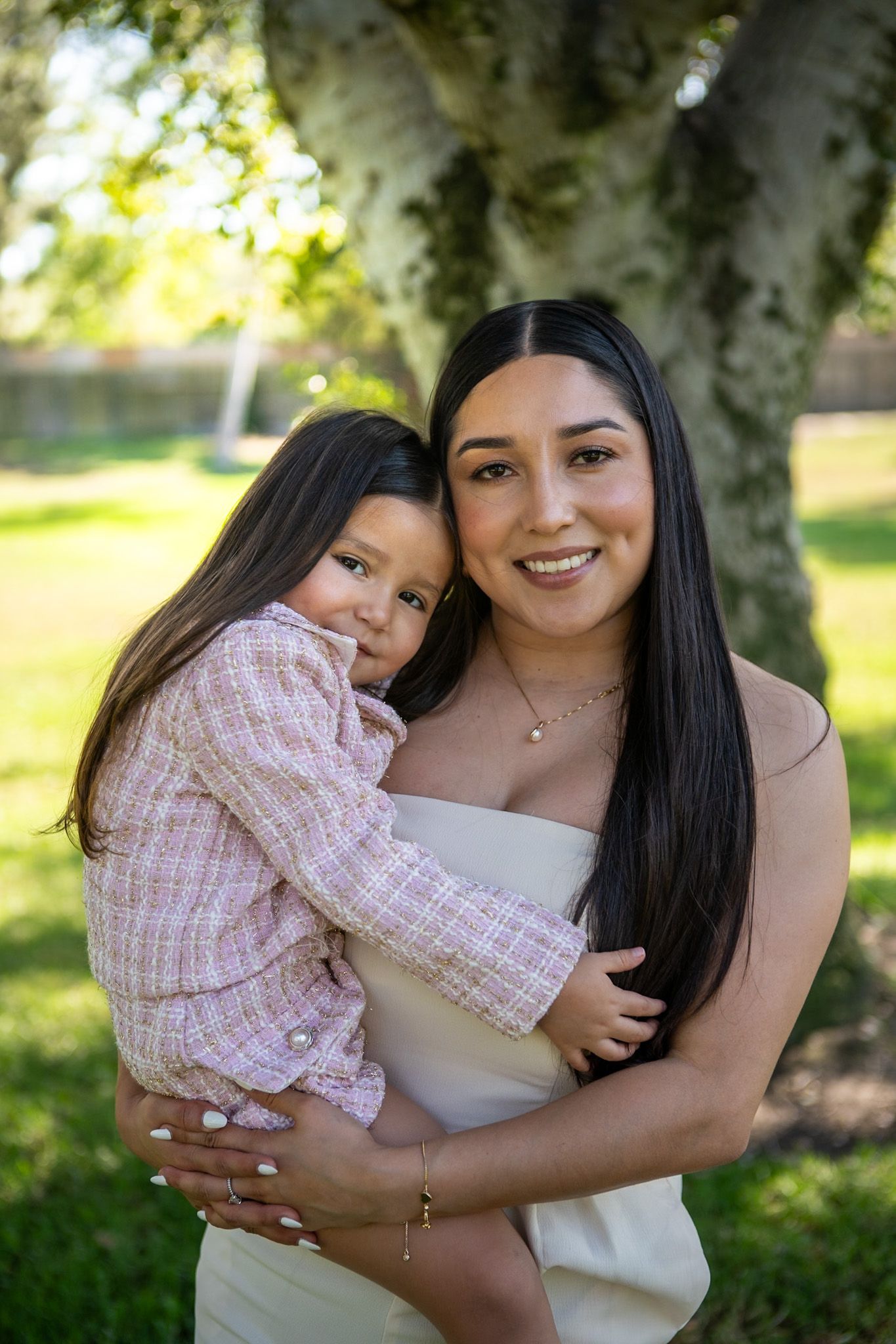 A series of candid outdoor photos showing tender embraces and joyful moments in a sunlit garden setting.
