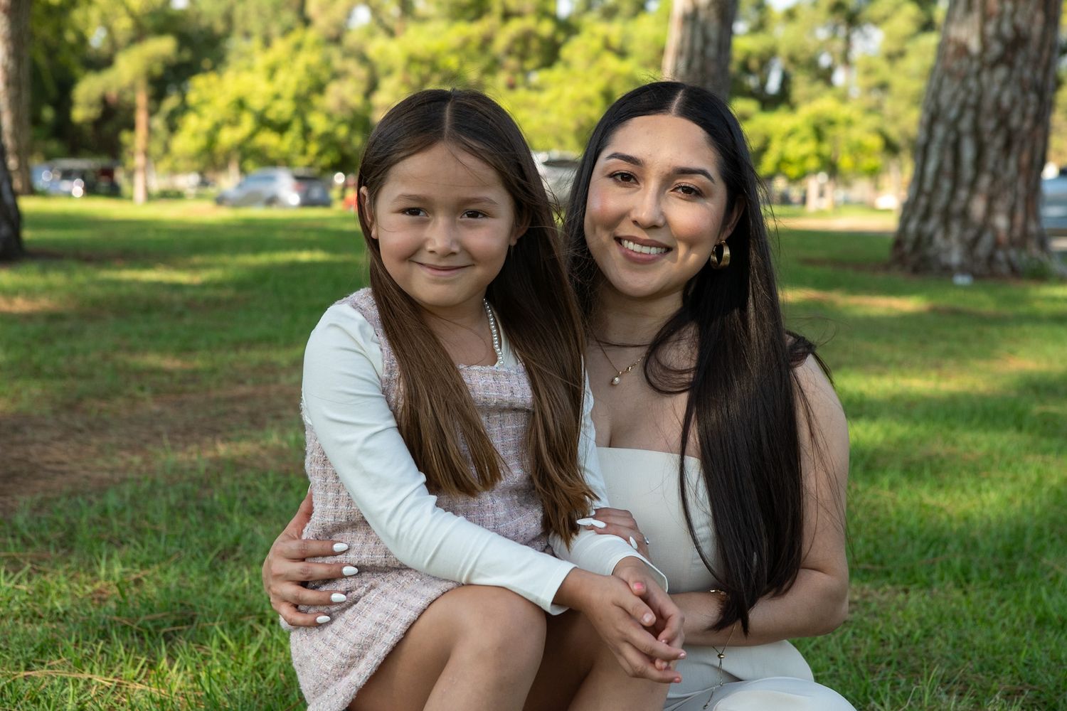 A series of tender outdoor portraits showing a parent and child sharing loving moments in a sunlit park setting.